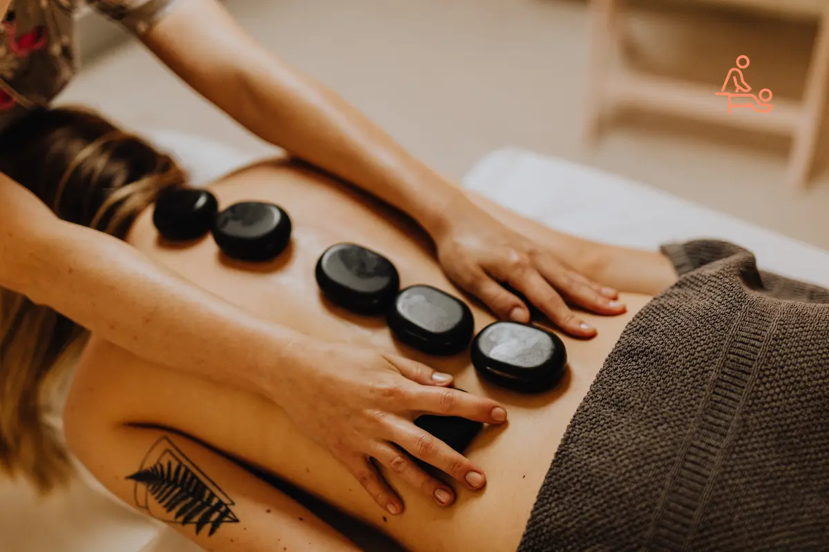 Hot Stone Massage therapy in a professional spa highlighting benefits of deep muscle relaxation, stress relief, improved circulation, and natural healing